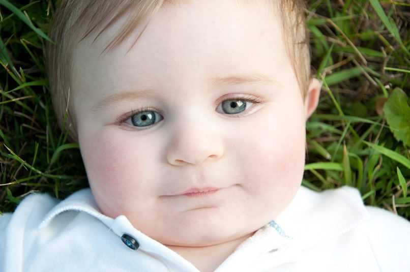 Smiling boy laying in grass