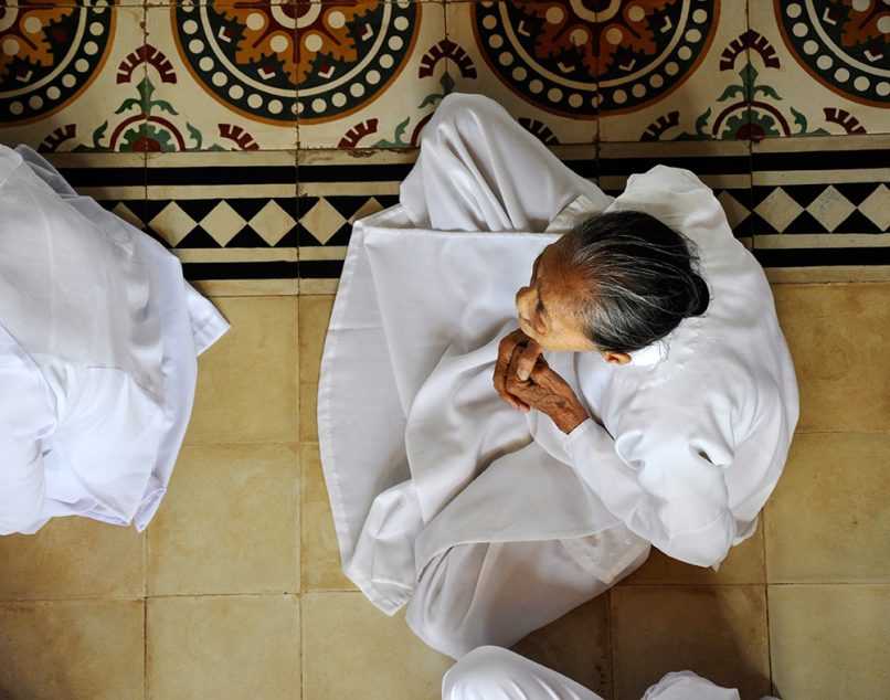 Woman praying in temple in Vietnam, seen from above