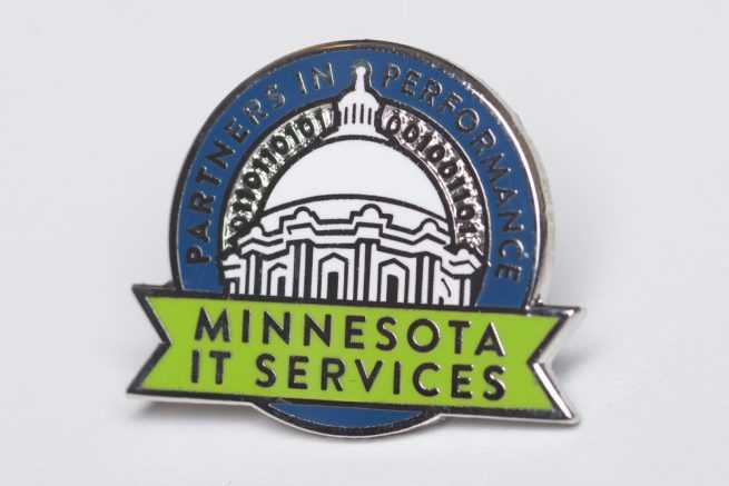 Minnesota IT Services lapel pin with image of capitol and binary code, with the text Partners in Performance