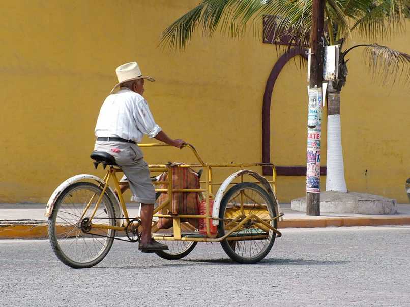 Elderly man riding bike in Mexico