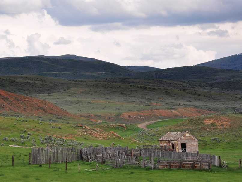 Decrepit ranch in Wyoming with stormy clouds overhead