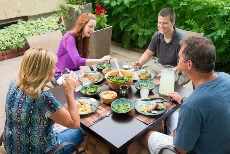 Family eating dinner at gas fire table
