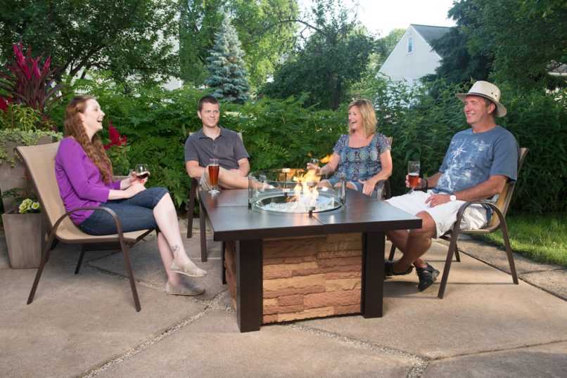 Family relaxing in front of a gas fire table