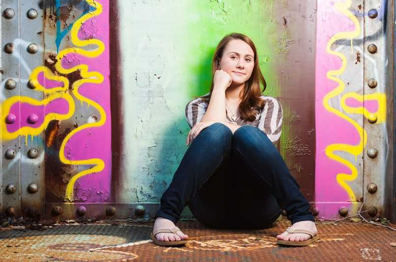 Senior portrait of girl in front of grafitti