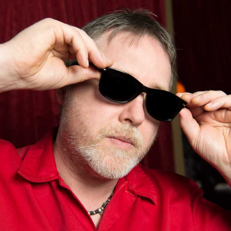 Man putting on sunglasses